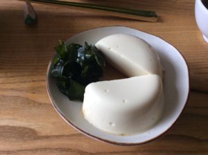 Silken Tofu made with different coagulates (nigari and gdl) - not a perfect shape, but a pretty good taste. I added some wakame salad with a ponzu dressing to go with it.