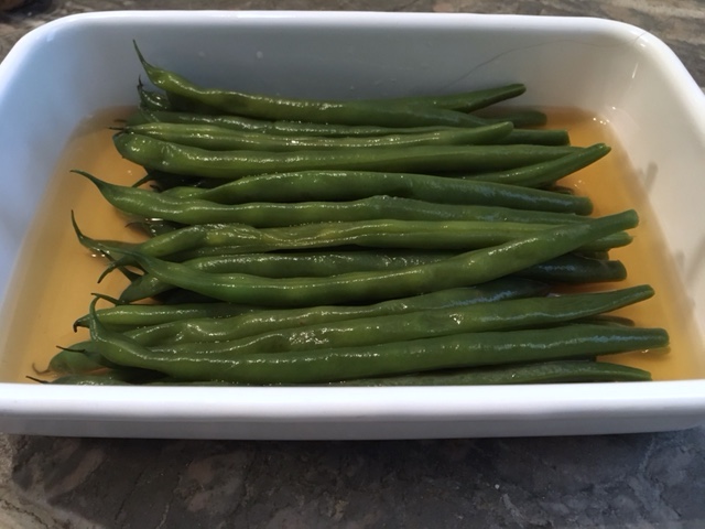 Green beans waiting in dashi to be plated