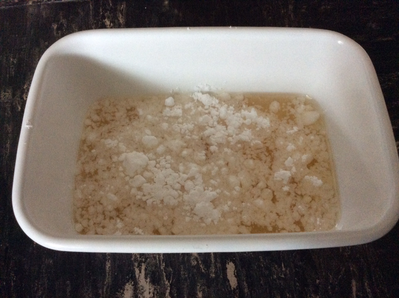 Waterkefir crystals covered with icing sugar. The sugar will melt and form a syrupy brownish liquid